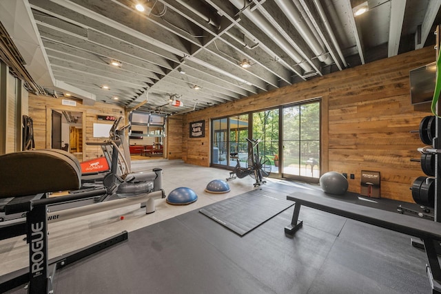 workout area featuring wood walls