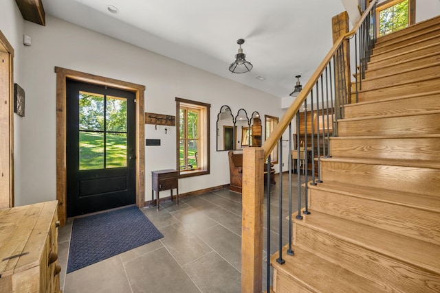 foyer with dark tile patterned floors