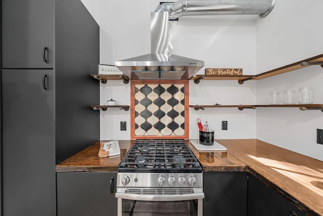 kitchen with island exhaust hood, butcher block countertops, and high end stainless steel range oven