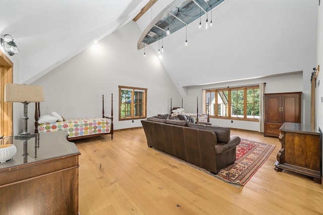 living room with beam ceiling, high vaulted ceiling, and light wood-type flooring