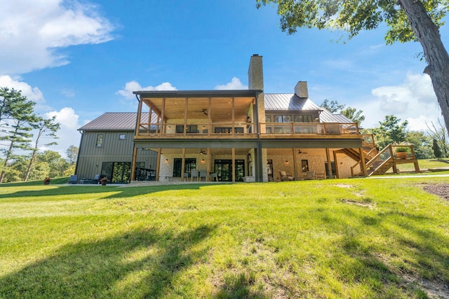 back of property featuring a yard, a deck, and ceiling fan