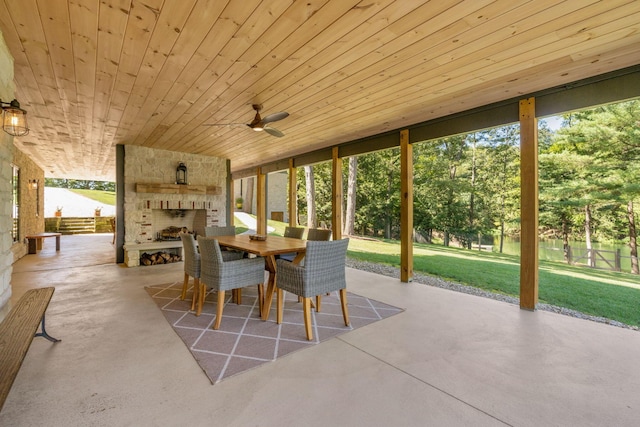 view of patio with a large fireplace and ceiling fan