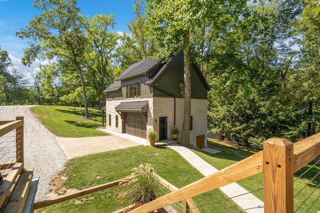 view of side of property featuring a garage and a lawn