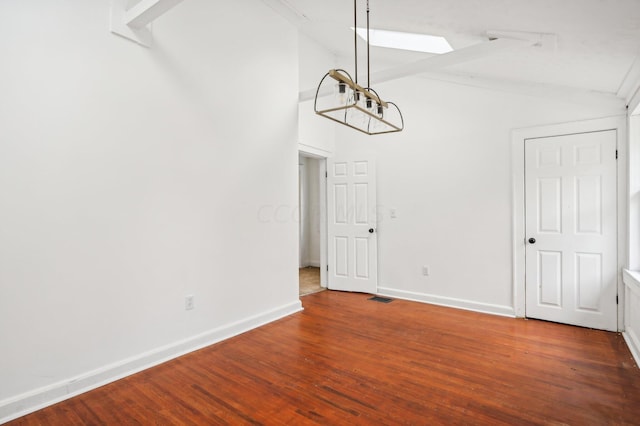 unfurnished dining area with hardwood / wood-style flooring and lofted ceiling