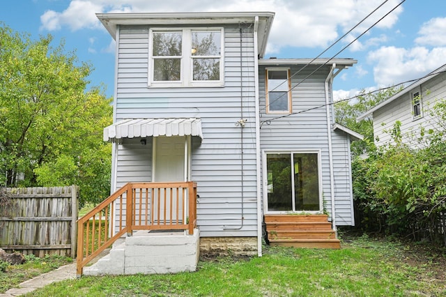 back of house with a lawn