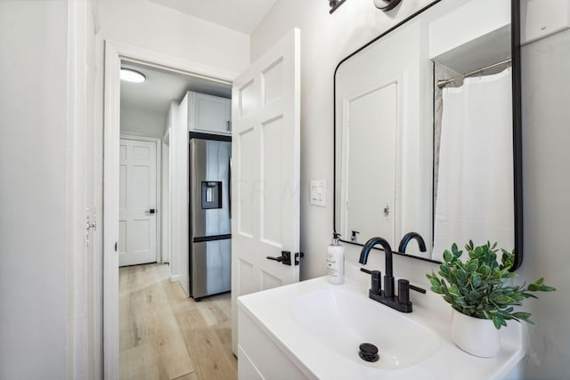 bathroom featuring vanity and hardwood / wood-style flooring