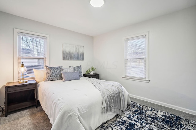 bedroom featuring dark carpet