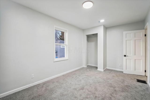 unfurnished bedroom with carpet floors and a closet