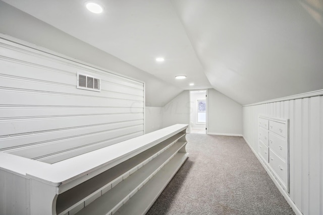 hall with carpet flooring and vaulted ceiling