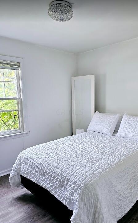 bedroom featuring dark hardwood / wood-style flooring