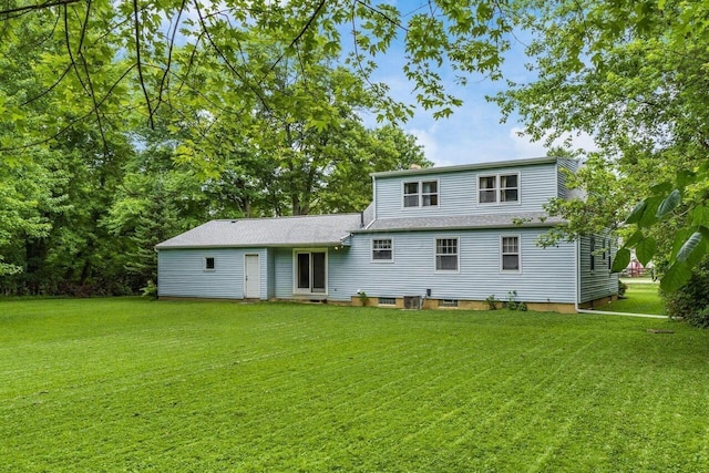 rear view of property featuring a yard