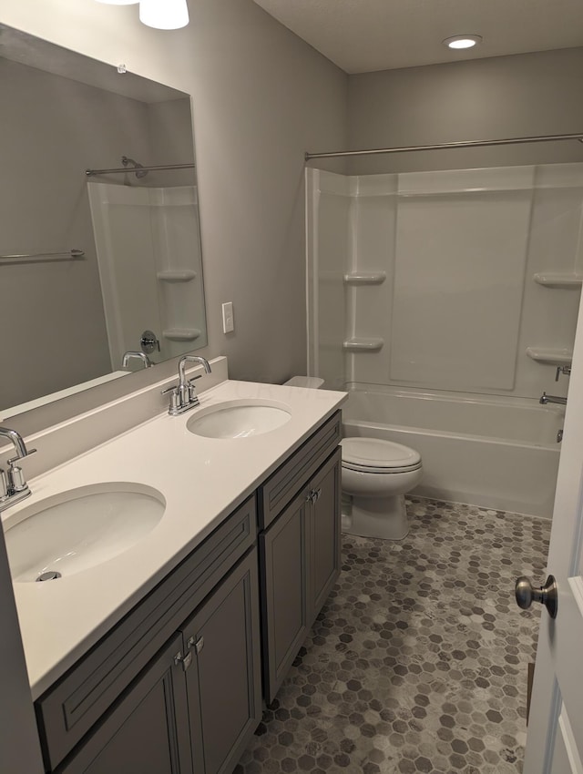 full bathroom featuring vanity, toilet, and washtub / shower combination