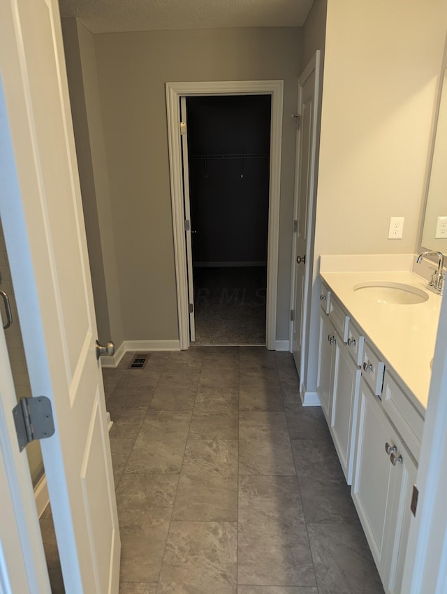 bathroom with vanity and a textured ceiling