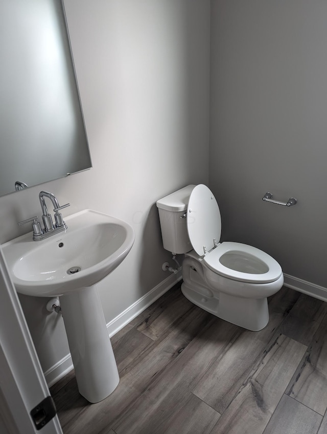 bathroom featuring toilet and hardwood / wood-style flooring