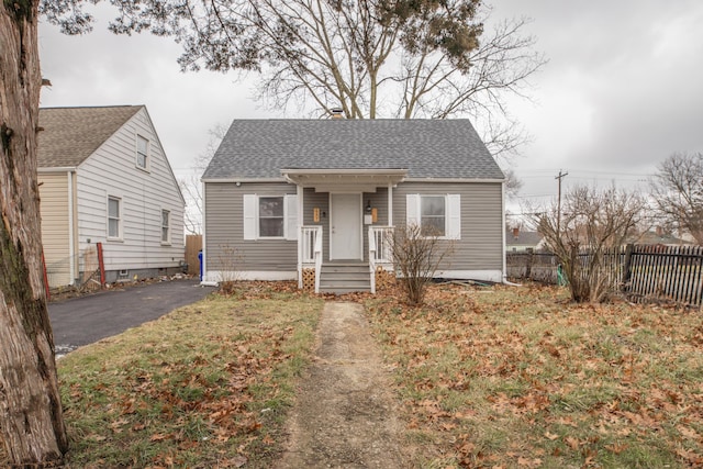 bungalow-style house featuring a front yard