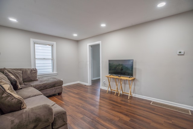 living room with dark hardwood / wood-style flooring