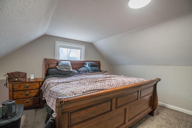 carpeted bedroom featuring a textured ceiling and lofted ceiling