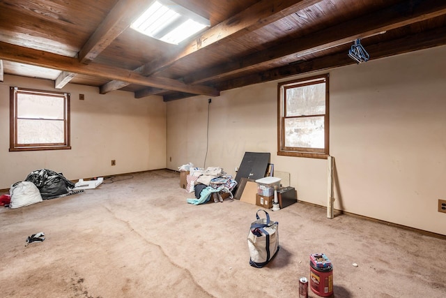 carpeted spare room with beam ceiling and wooden ceiling