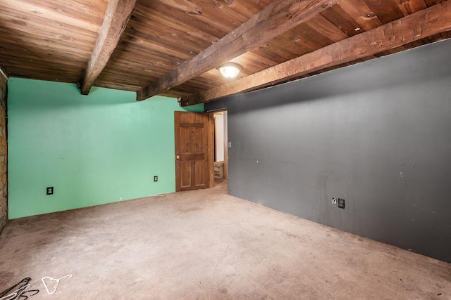 unfurnished room with carpet flooring, beam ceiling, and wooden ceiling