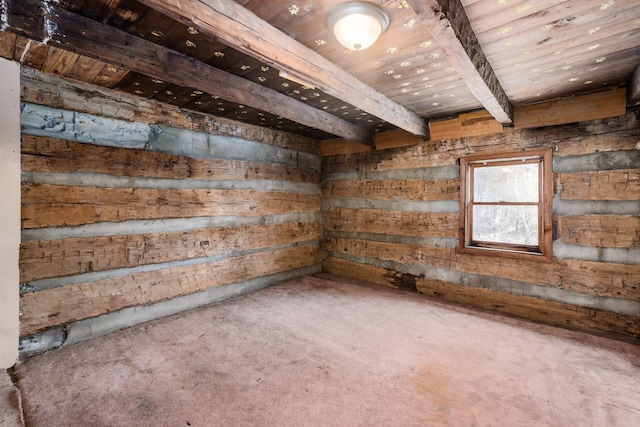 spare room featuring carpet flooring and wooden ceiling