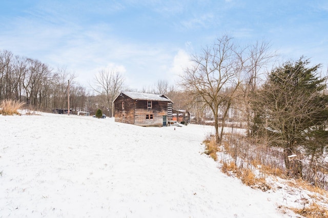 yard covered in snow featuring an outdoor structure