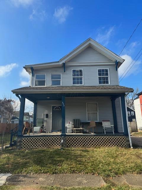 view of front facade with a front lawn and covered porch