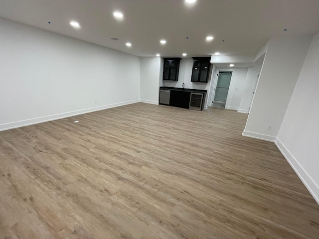 unfurnished living room with bar and dark wood-type flooring