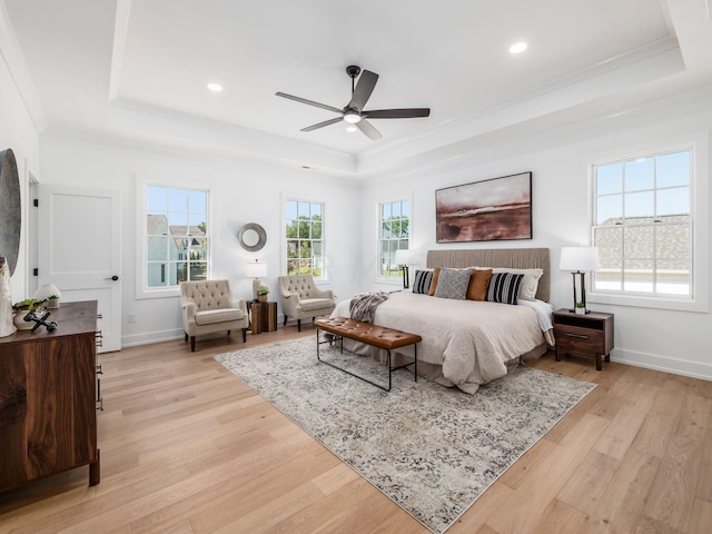 bedroom with ceiling fan, light hardwood / wood-style floors, and multiple windows