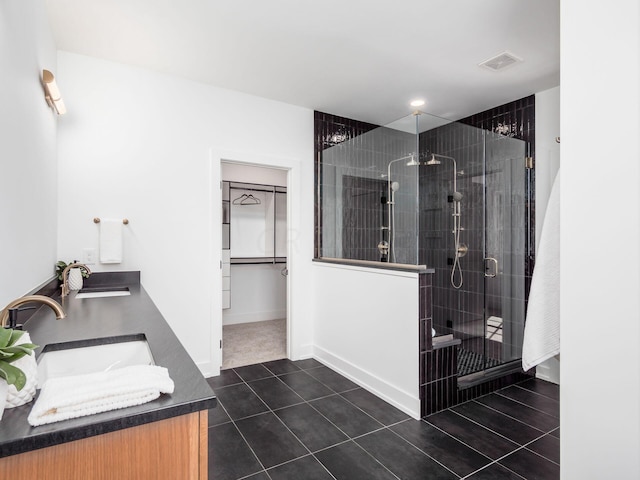 bathroom featuring vanity, tile patterned floors, and a shower with shower door