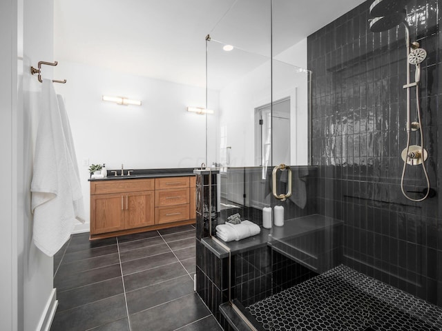 bathroom featuring vanity, tile patterned floors, and walk in shower