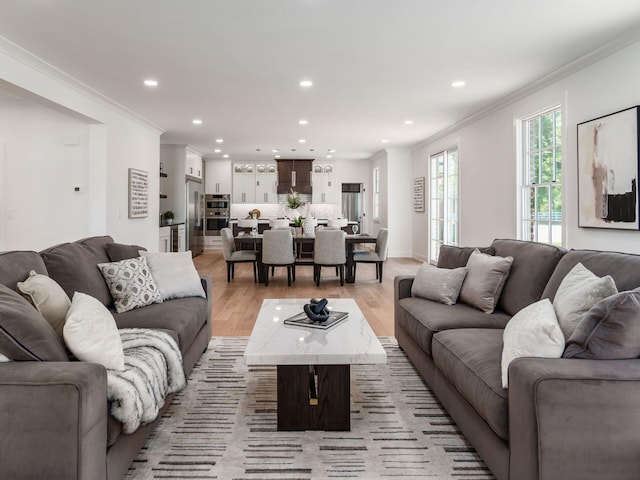 living room with light hardwood / wood-style floors and ornamental molding