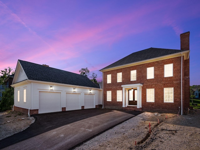 colonial inspired home with a garage