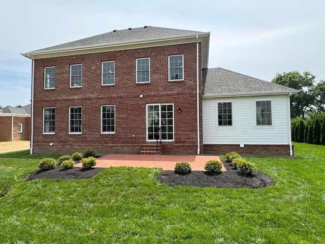 rear view of property featuring a yard and a patio area