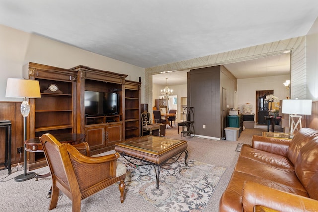 living room with light carpet and a chandelier