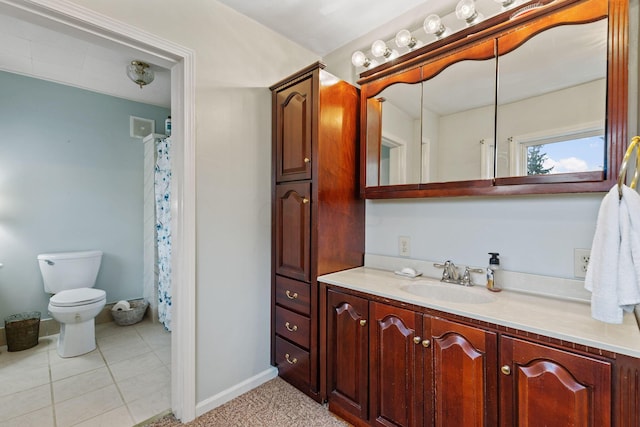 bathroom featuring tile patterned flooring, vanity, and toilet