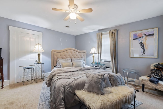 carpeted bedroom featuring ceiling fan and cooling unit