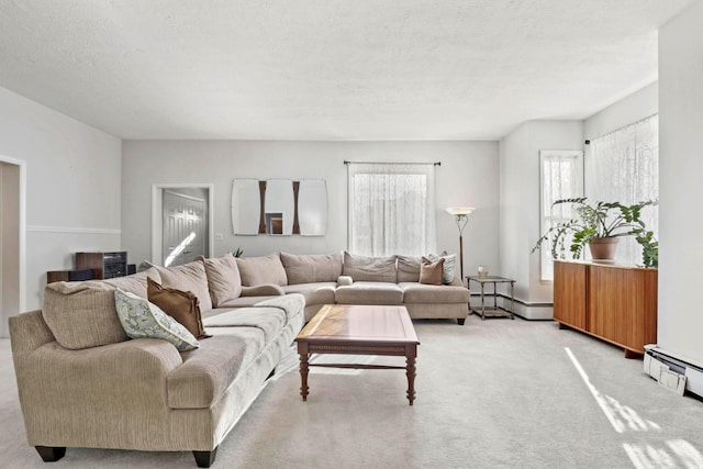 living room featuring light carpet, a textured ceiling, and a baseboard radiator