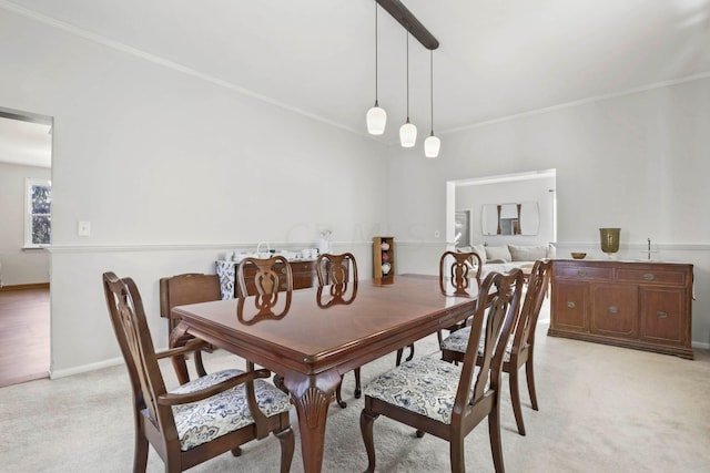 carpeted dining room with ornamental molding