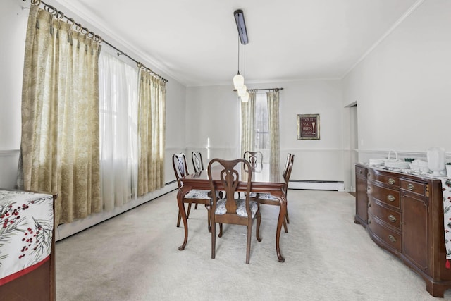 carpeted dining space featuring crown molding and a baseboard heating unit