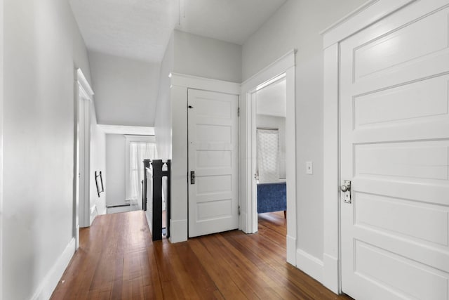 hallway featuring dark hardwood / wood-style floors and a baseboard heating unit