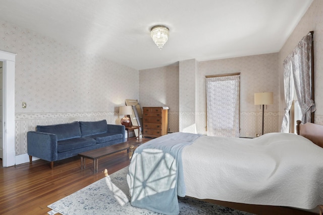 bedroom with dark hardwood / wood-style flooring