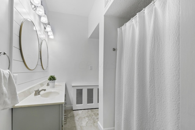 bathroom featuring radiator and vanity