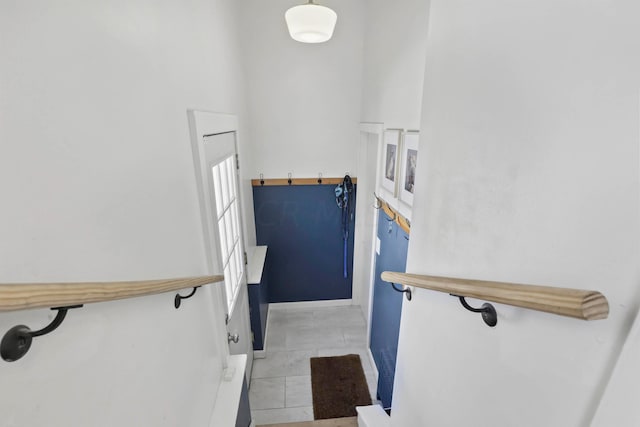 stairway featuring tile patterned flooring