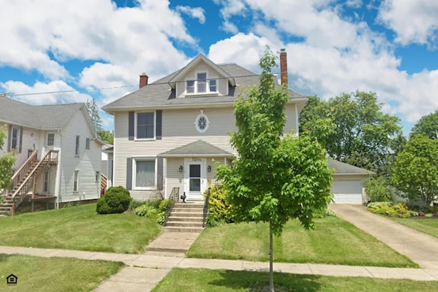 view of front facade with a front yard and a garage