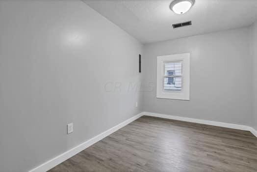 unfurnished room featuring wood-type flooring