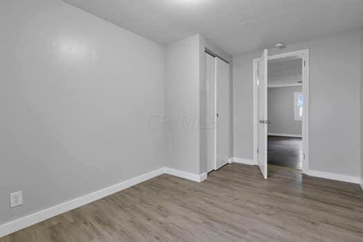 unfurnished bedroom featuring hardwood / wood-style flooring