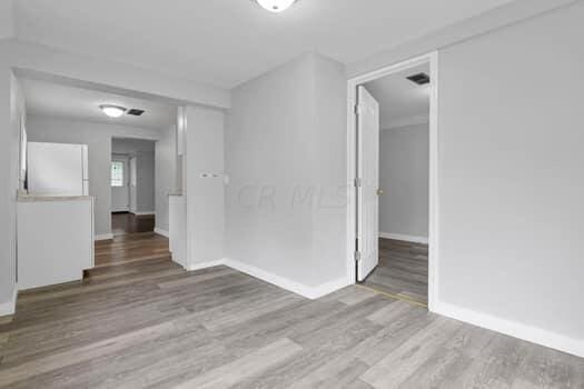 unfurnished room featuring wood-type flooring