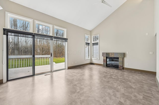 unfurnished living room featuring high vaulted ceiling, a tile fireplace, visible vents, and baseboards