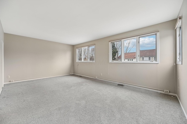 carpeted spare room with baseboards