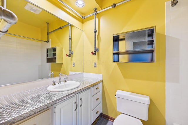 full bathroom featuring recessed lighting, vanity, and toilet